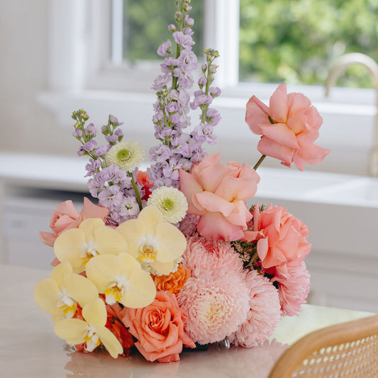 Colorful flower arrangement on a table with a blurred background