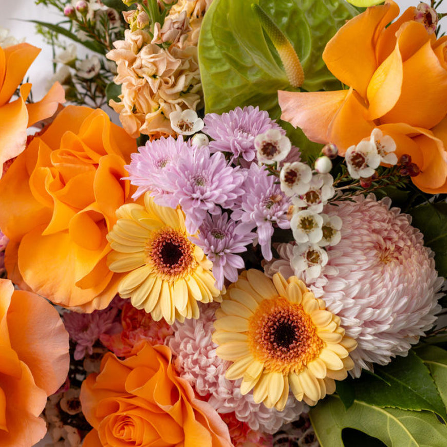 Bouquet of colorful flowers including orange, yellow, pink, and green.