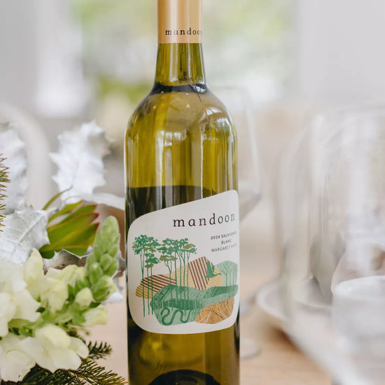 Bottle of Mandoon white wine on a table with floral decorations