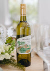 Bottle of Mandoon white wine on a table with floral decorations