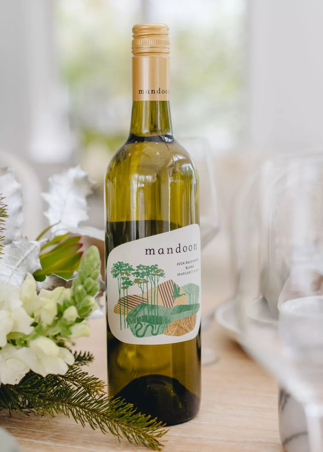 Bottle of Mandoon white wine on a table with floral decorations